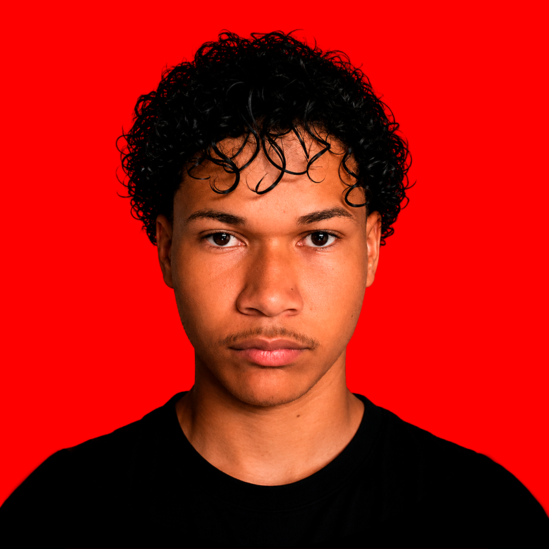 Portrait of Mael, video editor, lit with red rim lighting